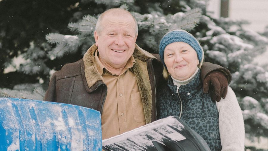 Two seniors shoveling snow